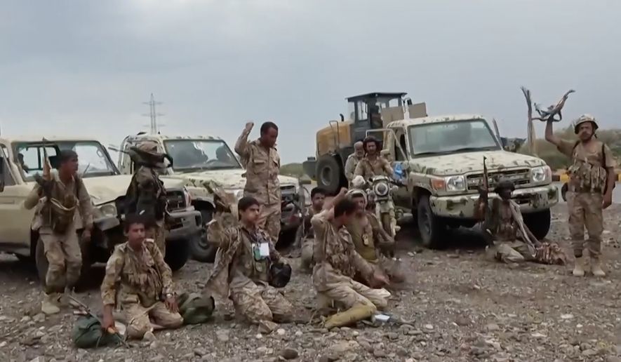 This image taken from undated video released by the Ansar Allah Media Office, the media arm of Yemen's Houthi rebels, on Saturday, Sept. 12, 2026, shows Houthi fighters chant after praying beside military vehicles during what the group says was their advance against Saudi-backed forces at an undisclosed location in southern Yemen. (Ansar Allah Media Office via AP)