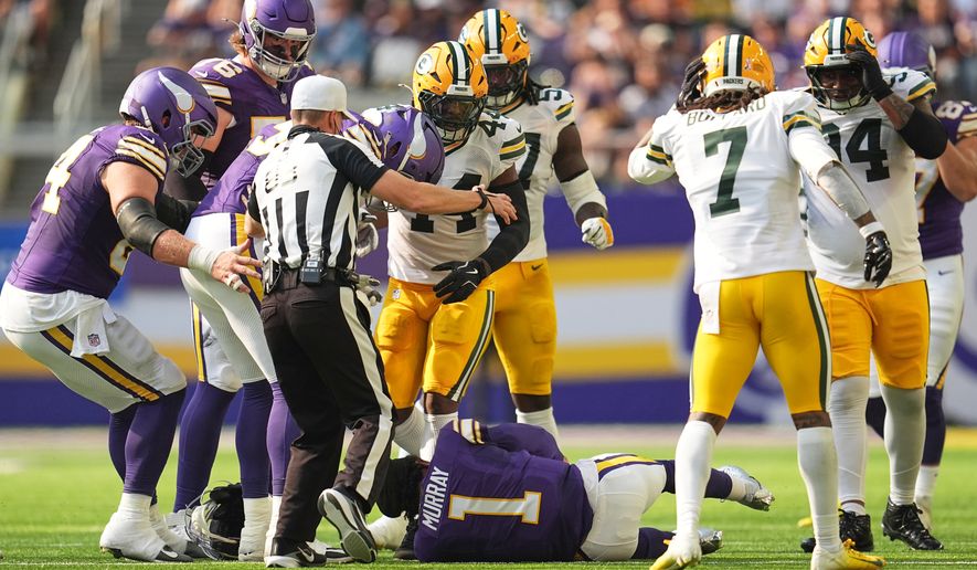 Minnesota Vikings and Green Bay Packers players look on after Vikings quarterback Kyler Murray was tackled during the first half of an NFL football game, Sunday, Sept. 13, 2026, in Minneapolis, Minn. (AP Photo/Abbie Parr)