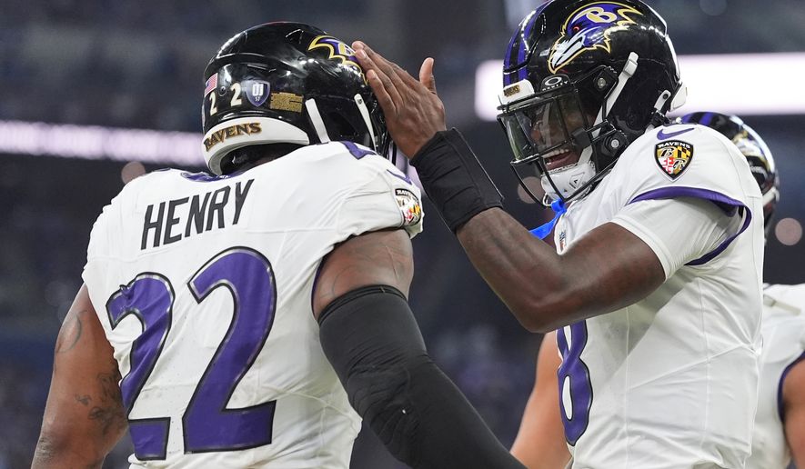 Baltimore Ravens' Lamar Jackson congratulates Derrick Henry on his touchdown run during the first half of an NFL football game against the Indianapolis Colts Sunday, Sept. 13, 2026, in Indianapolis. (AP Photo/Jeff Roberson)
