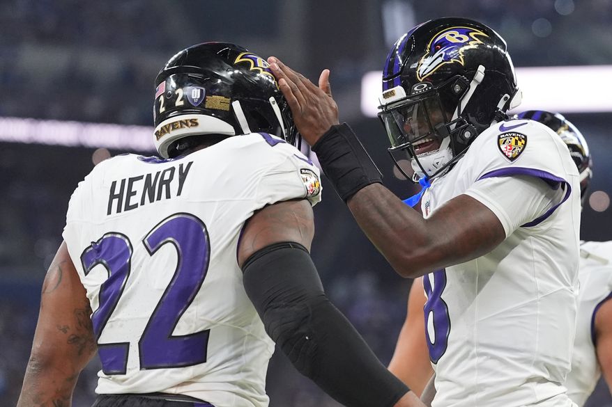 Baltimore Ravens' Lamar Jackson congratulates Derrick Henry on his touchdown run during the first half of an NFL football game against the Indianapolis Colts Sunday, Sept. 13, 2026, in Indianapolis. (AP Photo/Jeff Roberson)