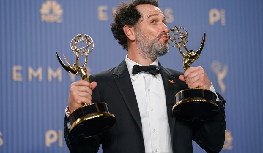 Matthew Rhys poses in the press room with the awards for outstanding lead actor in a limited or anthology series or movie for "The Beast In Me," and outstanding lead actor in a comedy series for "Widow's Bay" during the 78th Emmy Awards on Monday, Sept. 14, 2026, at the JW Marriott in Los Angeles. (Photo by Richard Shotwell/Invision/AP)