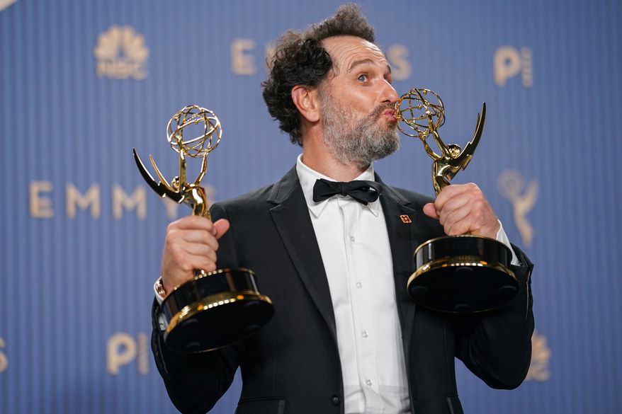 Matthew Rhys poses in the press room with the awards for outstanding lead actor in a limited or anthology series or movie for "The Beast In Me," and outstanding lead actor in a comedy series for "Widow's Bay" during the 78th Emmy Awards on Monday, Sept. 14, 2026, at the JW Marriott in Los Angeles. (Photo by Richard Shotwell/Invision/AP)