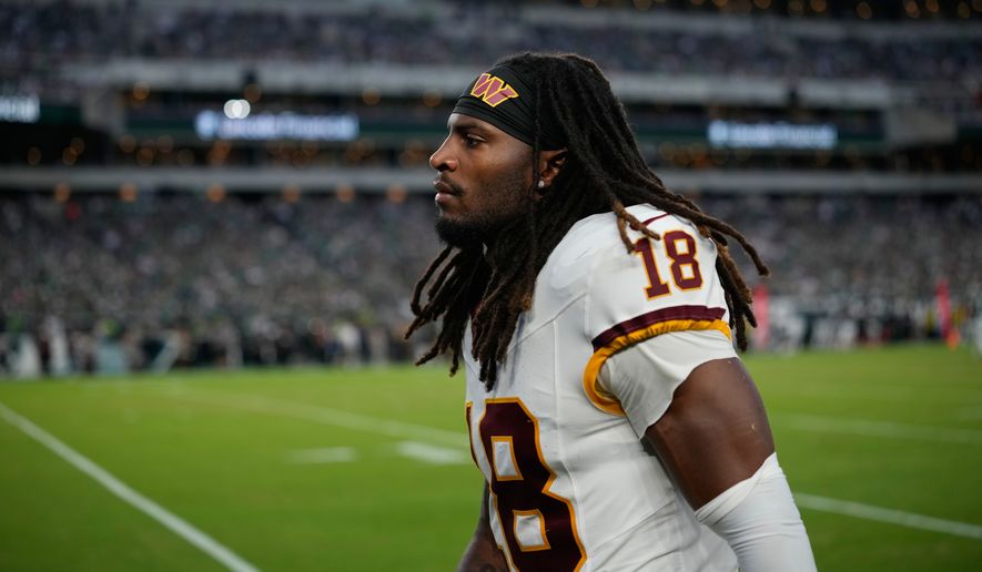 Washington Commanders safety Tyler Owens (18) leaves the field following an injury during the second half of an NFL football game against the Philadelphia Eagles, Sunday, Sept. 13, 2026, in Philadelphia. (AP Photo/Matt Slocum)
