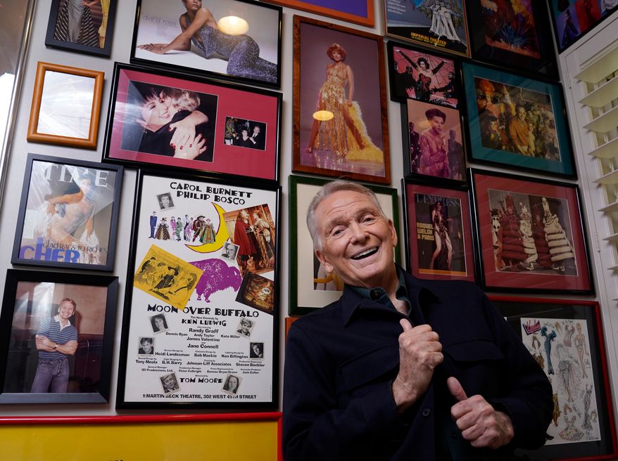 FILE - Costume and fashion designer Bob Mackie poses amongst memorabilia from his career at his home in Palm Springs, Calif., on Oct. 20, 2021. (AP Photo/Chris Pizzello, File)