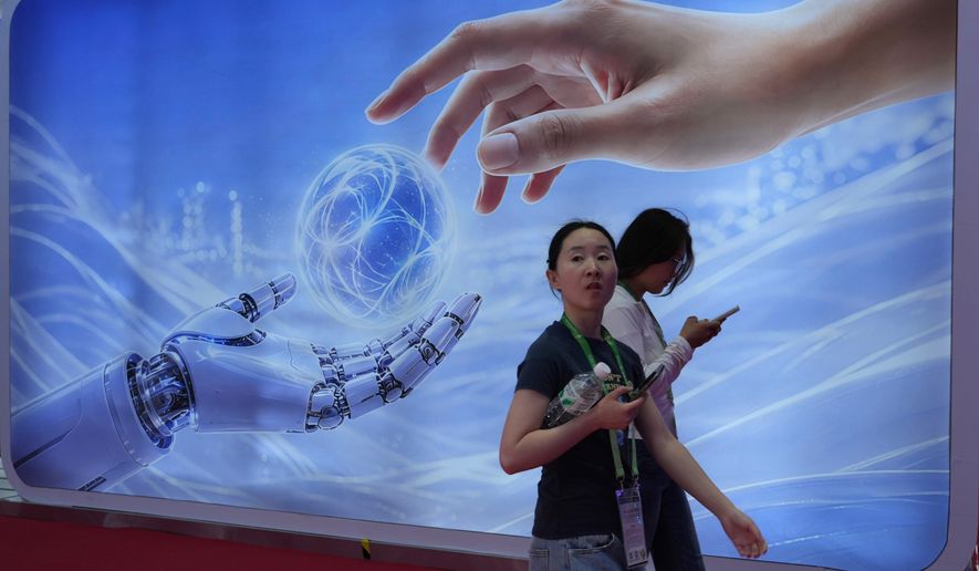 Visitors walk past a display depicting artificial intelligence and a human hand at the China International Supply Chain Expo in Beijing on Monday, June 22, 2026. (AP Photo/Ng Han Guan)