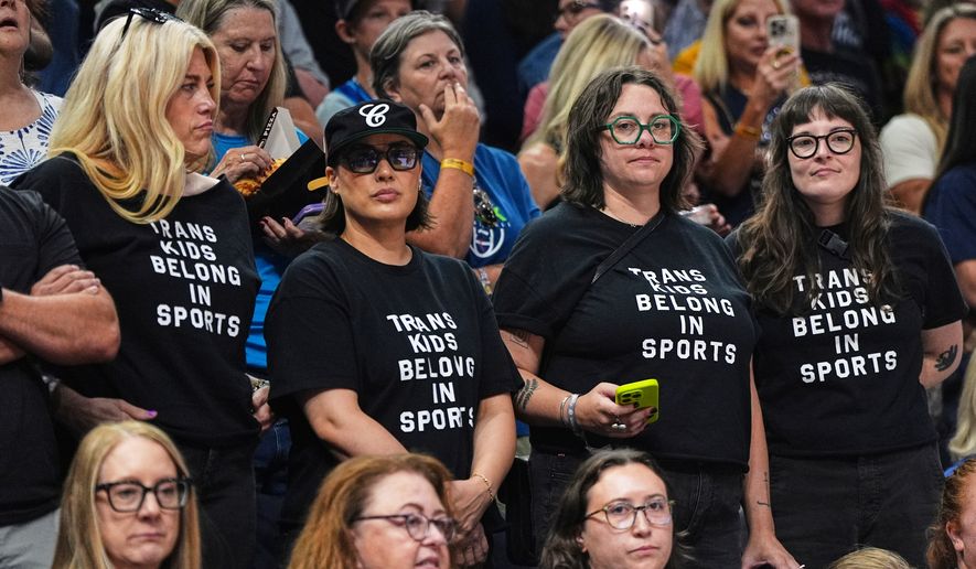 Fans wear shirts saying, "Trans Kids Belong In Sports," during a WNBA basketball game between the Minnesota Lynx and the Indiana Fever, Aug. 2, 2026, in Minneapolis. (AP Photo/Abbie Parr)