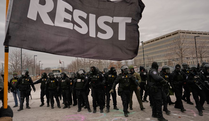 FILE - Federal immigration officers confront protesters outside Bishop Henry Whipple Federal Building, Jan. 15, 2026, in Minneapolis. (AP Photo/John Locher, File)