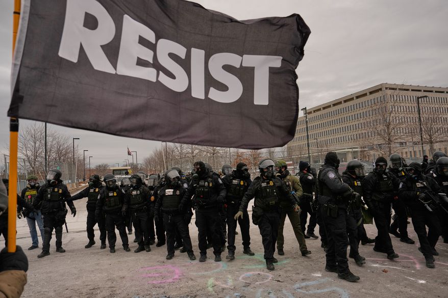 FILE - Federal immigration officers confront protesters outside Bishop Henry Whipple Federal Building, Jan. 15, 2026, in Minneapolis. (AP Photo/John Locher, File)