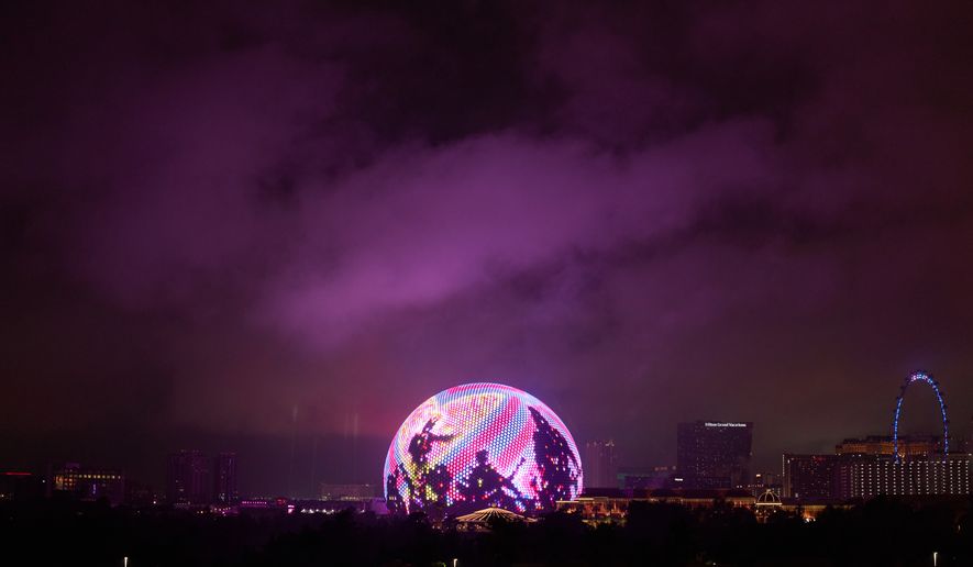 Lights from the Sphere illuminate rain clouds above The Strip, Nov. 15, 2025, in Las Vegas. (AP Photo/John Locher, File)