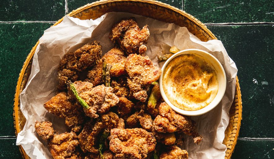 This image released by Voracious shows a recipe for sesame cumin chicken, from the cookbook "The Chinese Way" by Betty Liu. (Betty Liu/Voracious via AP)