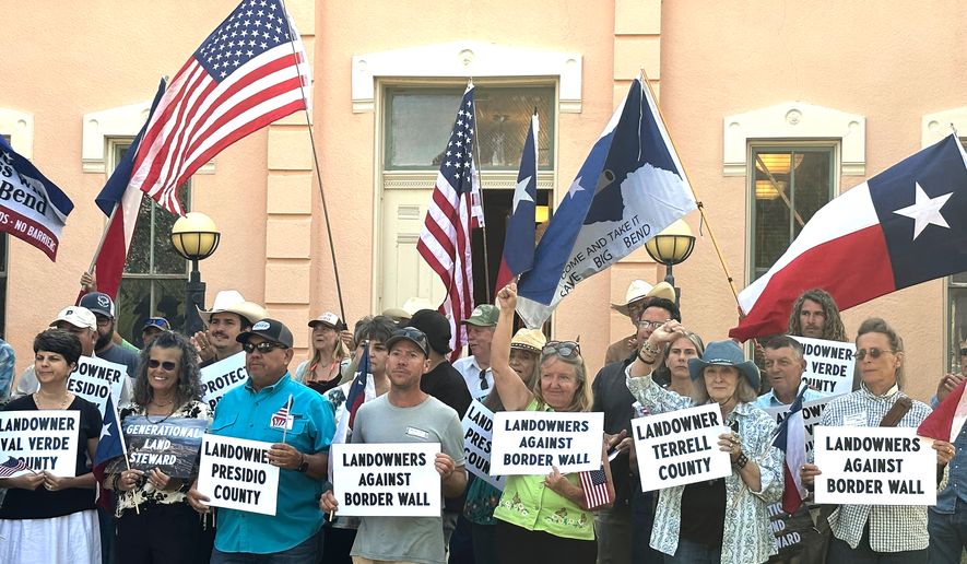 Landowners and other supporters hold signs against the Trump administration's plans to build a border wall and other infrastructure in Texas' remote Big Bend region, Monday, Sept. 14, 2026, in Marfa, Texas. (AP Photo/Rebecca Santana)