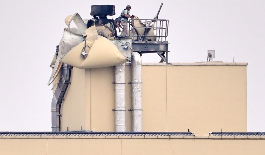 U.S. embassy personnel inspect the damage caused by a bombing in Baghdad, March 14, 2026. (AP Photo/Hadi Mizban, File)