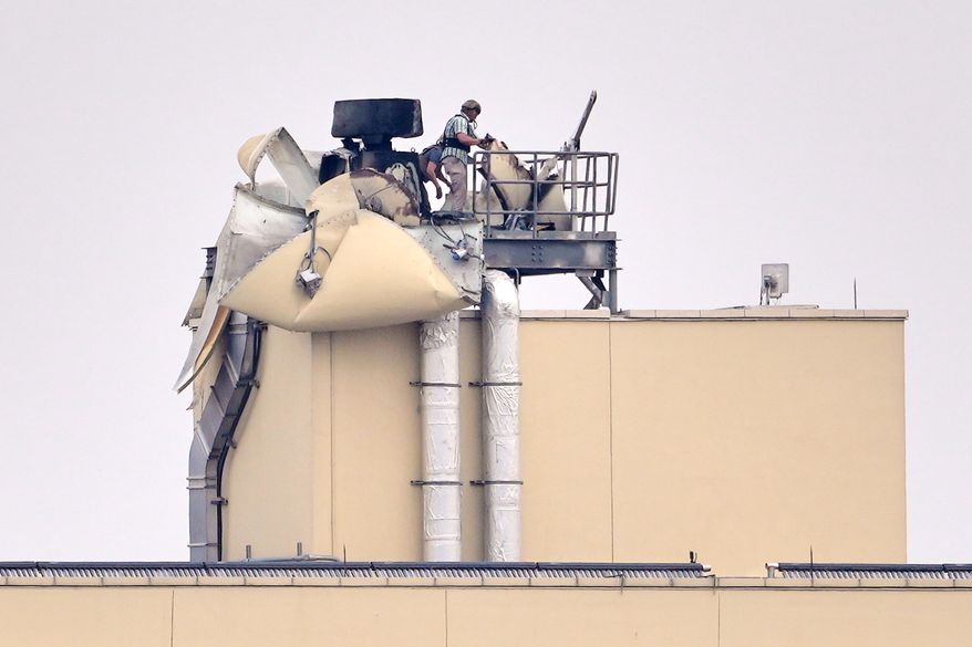 U.S. embassy personnel inspect the damage caused by a bombing in Baghdad, March 14, 2026. (AP Photo/Hadi Mizban, File)