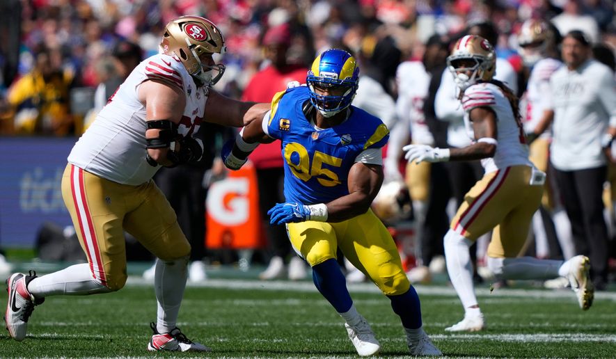 FILE - Los Angeles Rams defensive end Myles Garrett (95) tries to get past San Francisco 49ers offensive tackle Colton McKivitz, left, in the first half of an NFL football game in Melbourne, Australia, on Sept. 11, 2026. (AP Photo/Doug Benc, File)