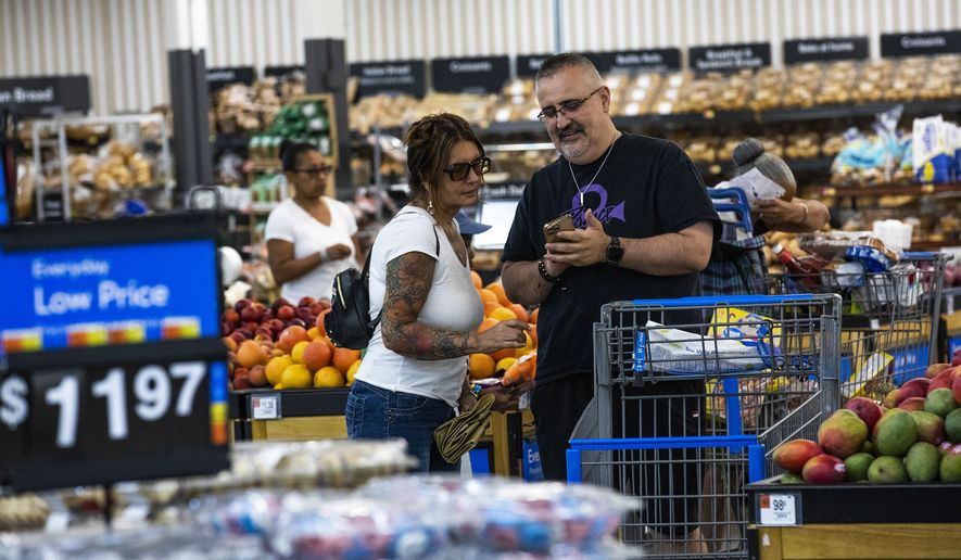 People buy groceries at a Walmart Superstore in Secaucus, New Jersey, Thursday, July 11, 2024. (AP Photo/Eduardo Munoz Alvarez)