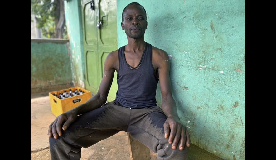 In this photo taken with a smartphone, David Nabutsilili, a rainmaker, poses for a photo in Namisindwa, Uganda, Tuesday, Sept. 3, 2026. (AP Photo/Rodney Muhumuza)