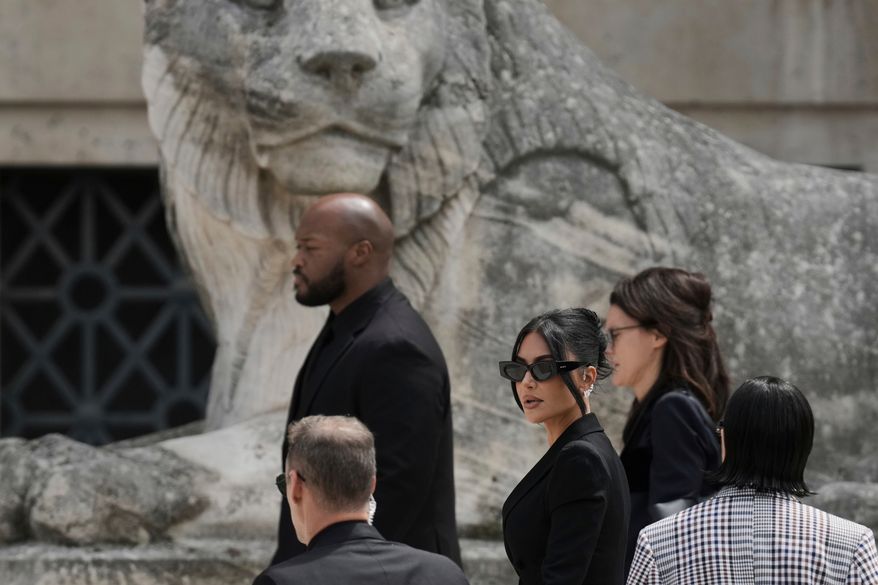 Kim Kardashian, center, arrives to testify regarding a robbery of millions of dollars in jewels from her Paris hotel room in 2016, in Paris on May 13, 2025. (AP Photo/Aurelien Morissard, File)