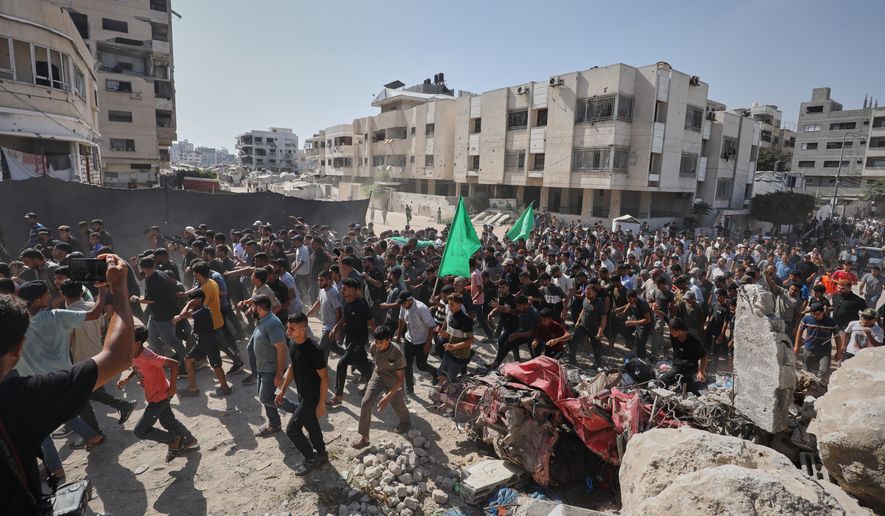 Palestinians carry the body of Ahmad Al-Batsh, a Qassam Brigades commander in Jabaliya, the military wing of Hamas, during his funeral after he was killed in an Israeli airstrike, in Gaza City, Tuesday, Sept. 15, 2026. (AP Photo/Yousef Al Zanoun)