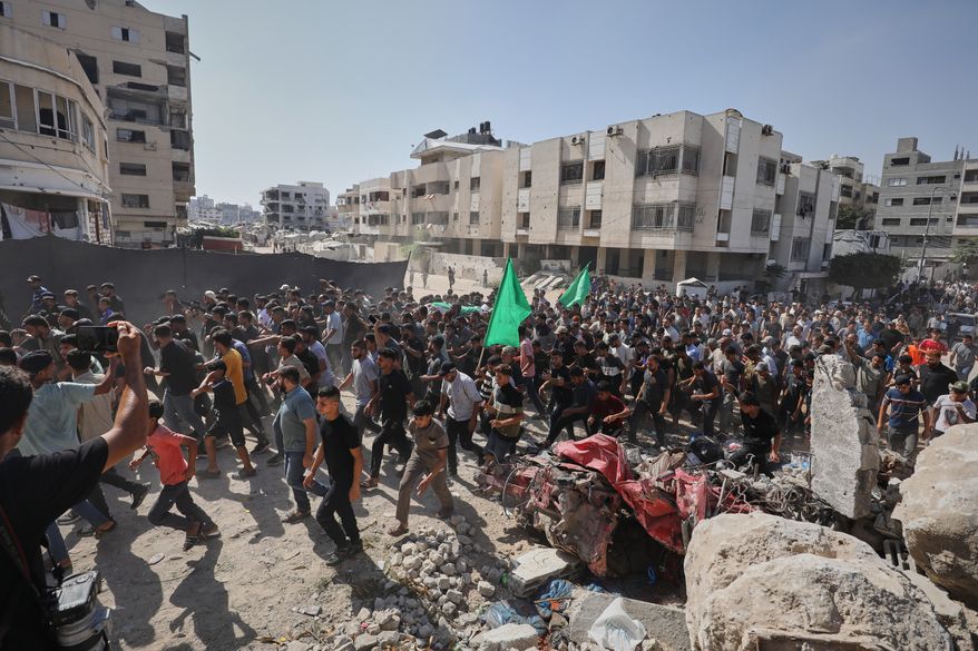 Palestinians carry the body of Ahmad Al-Batsh, a Qassam Brigades commander in Jabaliya, the military wing of Hamas, during his funeral after he was killed in an Israeli airstrike, in Gaza City, Tuesday, Sept. 15, 2026. (AP Photo/Yousef Al Zanoun)