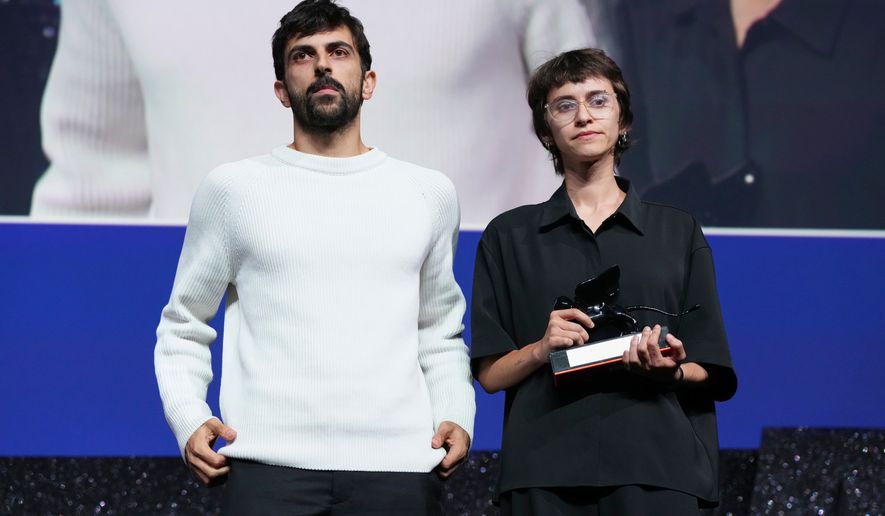 Directors Yuval Abraham, left, and Rachel Szor pose for photographers after accepting the special jury prize for the film 'Naza' during the closing ceremony of the 83rd edition of the Venice Film Festival in Venice, Italy, on Saturday, Sept. 12, 2026. (Photo by Scott A Garfitt/Invision/AP)