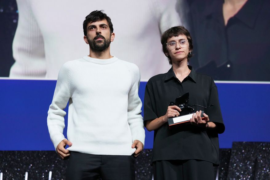 Directors Yuval Abraham, left, and Rachel Szor pose for photographers after accepting the special jury prize for the film 'Naza' during the closing ceremony of the 83rd edition of the Venice Film Festival in Venice, Italy, on Saturday, Sept. 12, 2026. (Photo by Scott A Garfitt/Invision/AP)