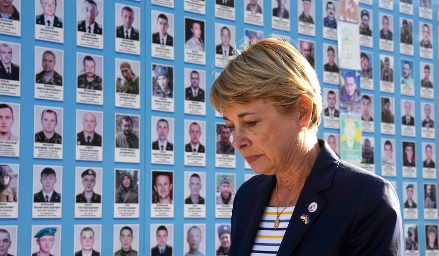 Monaco's Foreign Minister Isabelle Berro-Amadei walks past the Memory Wall of Fallen Defenders of Ukraine in Kyiv, Ukraine, Tuesday, Sept. 15, 2026. (AP Photo/Efrem Lukatsky)