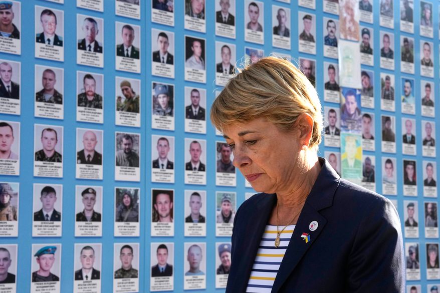 Monaco's Foreign Minister Isabelle Berro-Amadei walks past the Memory Wall of Fallen Defenders of Ukraine in Kyiv, Ukraine, Tuesday, Sept. 15, 2026. (AP Photo/Efrem Lukatsky)