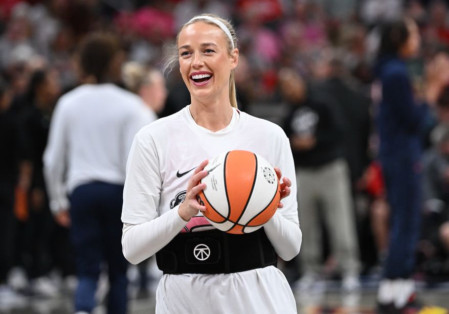 Indiana Fever guard Sophie Cunningham smiles while warming up before a WNBA basketball game against the Connecticut Sun, Friday, Aug. 28, 2026, in Indianapolis. (AP Photo/Marc Lebryk)