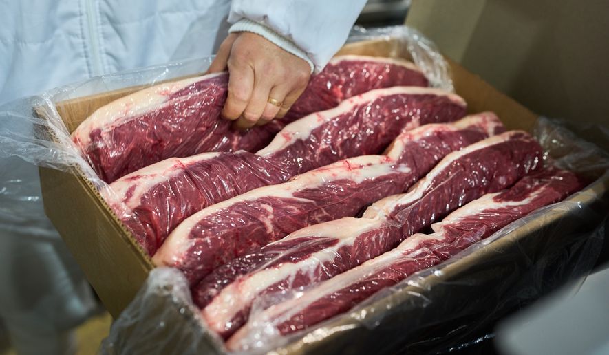 A worker checks vacuum-packed steaks ready for export at the Frigolar beef processing plant in La Plata, Argentina, Thursday, Nov. 6, 2025. (AP Photo/Rodrigo Abd)