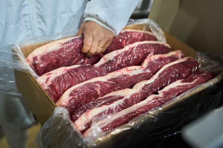 A worker checks vacuum-packed steaks ready for export at the Frigolar beef processing plant in La Plata, Argentina, Thursday, Nov. 6, 2025. (AP Photo/Rodrigo Abd)