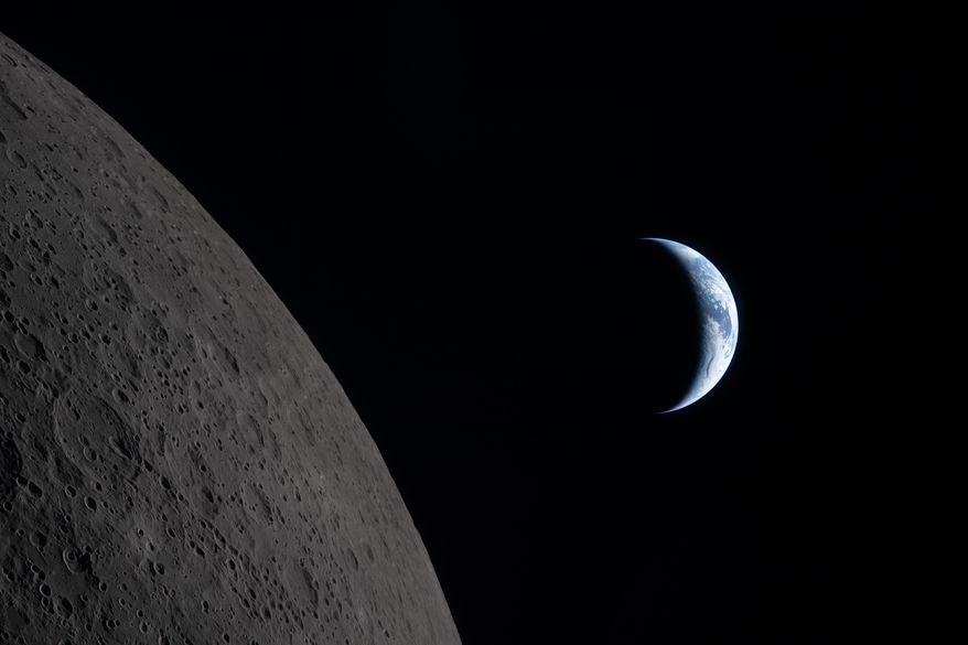 In this image provided by NASA, the Artemis II crew captured this view of the Earth next to the Moon before Earthset during a lunar flyby, Monday, April 6, 2026. (NASA via AP)