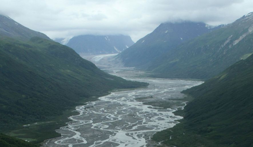 This photo taken July 5, 2013, in Lake Clark Pass near Port Alsworth, Alaska, shows a river valley cutting through the mountains. Many float planes will fly through the pass as they take day-trippers to Katmai National Park and Preserve to see the brown bears. (AP Photo/Mark Thiessen)