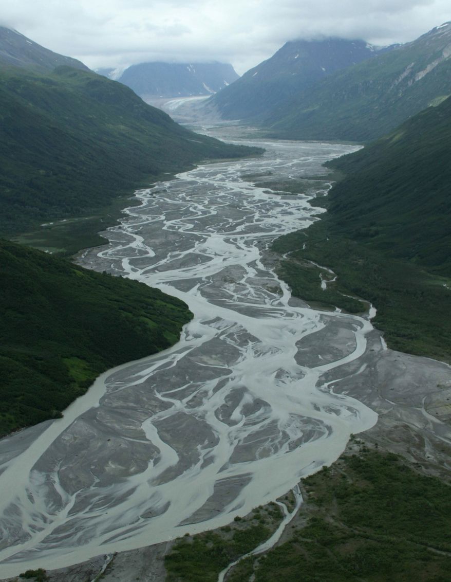 This photo taken July 5, 2013, in Lake Clark Pass near Port Alsworth, Alaska, shows a river valley cutting through the mountains. Many float planes will fly through the pass as they take day-trippers to Katmai National Park and Preserve to see the brown bears. (AP Photo/Mark Thiessen)