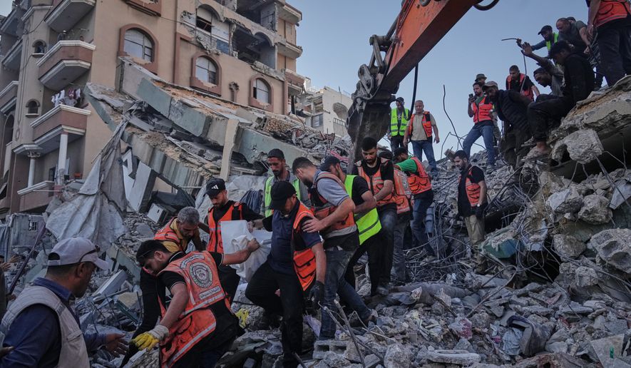 Palestinian civil defense crews carry a body from the rubble of a collapsed building that housed displaced Palestinians and was heavily damaged during the Israel-Hamas war, in Gaza City, Wednesday, Sept. 16, 2026. (AP Photo/Jehad Alshrafi)