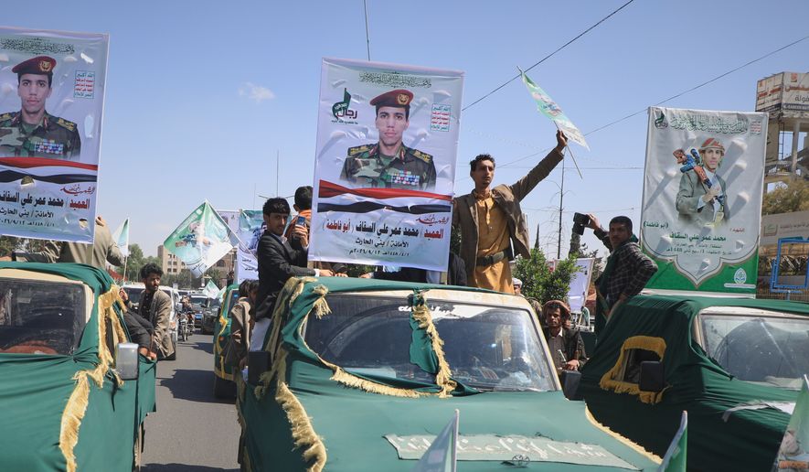 Pickup trucks travel in a mass funeral procession for Houthi officers and other military personnel in Sanaa, Yemen, Wednesday, Sept. 16, 2026. (AP Photo)