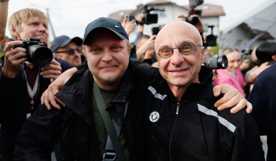 Dzmitry Navazhylau, right, one of the released Belarusian prisoners, is welcomed by his colleagues upon his arrival in Vilnius, Lithuania, Wednesday, Sept. 16, 2026. (AP Photo/Mindaugas Kulbis)