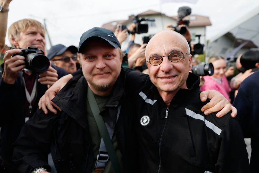 Dzmitry Navazhylau, right, one of the released Belarusian prisoners, is welcomed by his colleagues upon his arrival in Vilnius, Lithuania, Wednesday, Sept. 16, 2026. (AP Photo/Mindaugas Kulbis)
