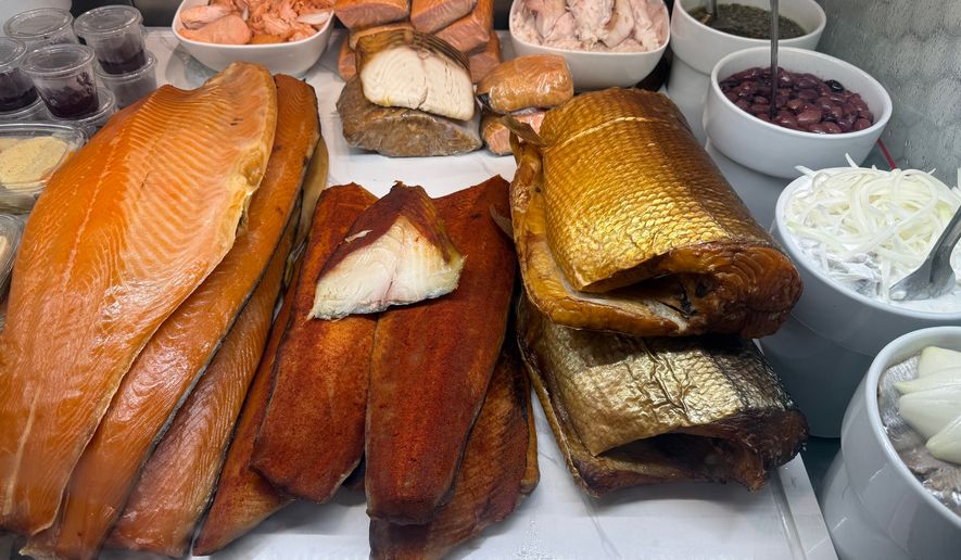 Various smoked fish are displayed behind the counter at Tal Bagels in New York on Sept. 13, 2026. (Katie Workman via AP)