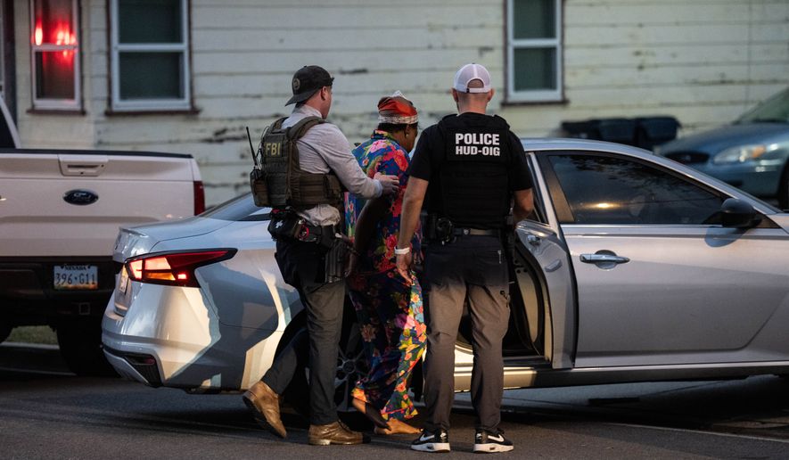 Lakiya Malone, center, charged with fraud involving federal homelessness aid programs, is arrested by federal agents in Los Angeles, Wednesday, Sept. 16, 2026. (AP Photo/Jae C. Hong)