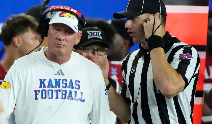 Kansas head coach Lance Leipold talks with an official during the second half of an NCAA college football game against Missouri, Friday, Sept. 11, 2026, in Lawrence, Kan. (AP Photo/Charlie Riedel)