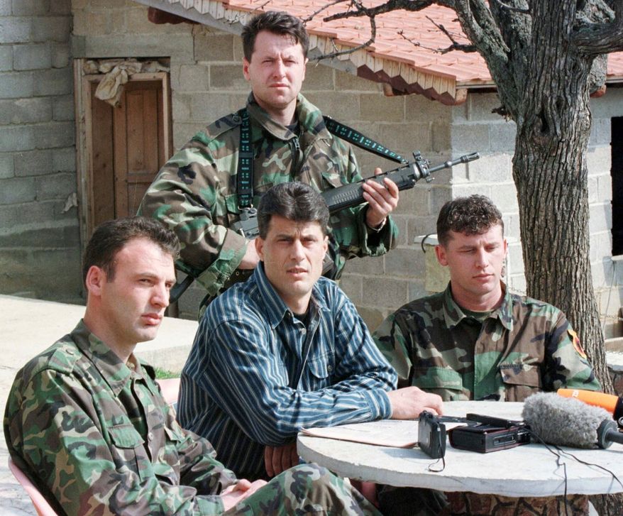FILE - Hashim Thaci, head of the Kosovo Albanian negotiation team and head of the Kosovo Liberation Army political directorate, center, addresses a press conference in a secret location in central Kosovo, Saturday, March 13, 1999. (AP Photo/Visar Kryeziu, File)