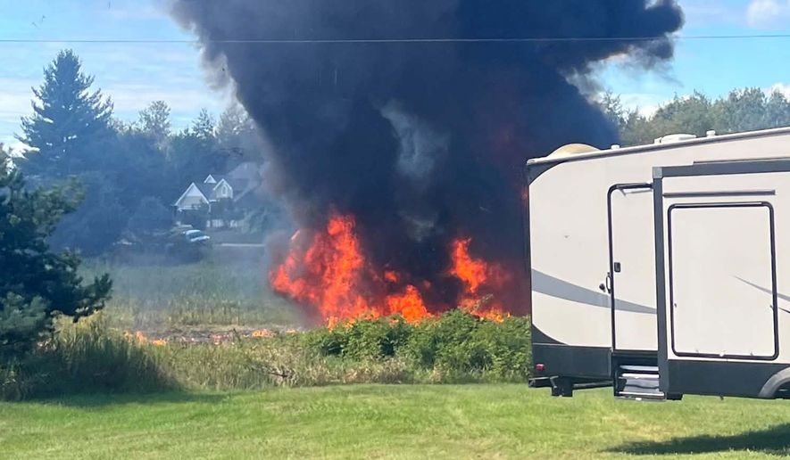 Smoke rises after an F-16 fighter jet crashed in a rural area near Traverse City, Mich., Thursday, Sept. 17, 2026. (Rebecca Lamberson via AP)