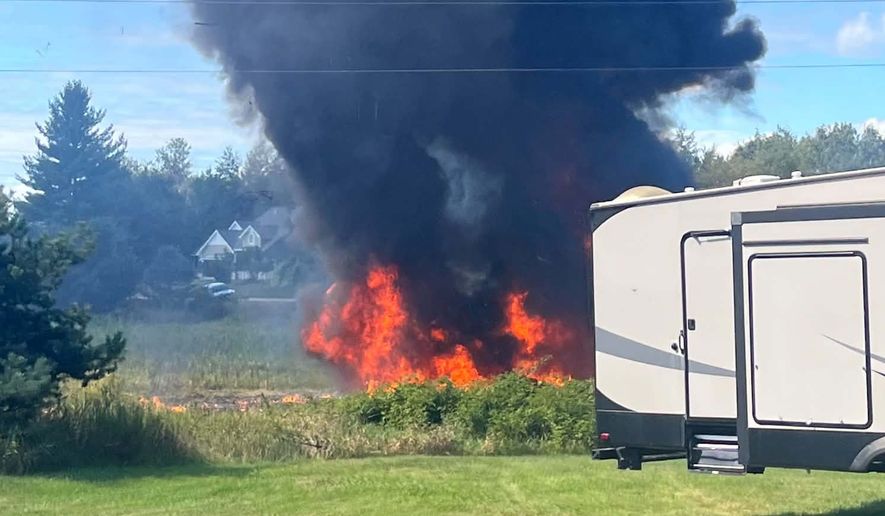 Smoke rises after an F-16 fighter jet crashed in a rural area near Traverse City, Mich., Thursday, Sept. 17, 2026. (Rebecca Lamberson via AP)