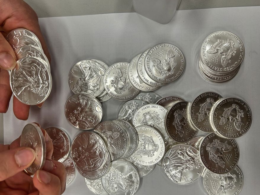 This handout photo released by Norwegian economic crime investigators on Thursday, Sept. 17, 2026, shows the U.S. "American Eagle" silver coins discovered by police in a van that was stopped after being driven "erratically" outside Oslo in April 2025. (Norwegian economic crime investigators via AP)
