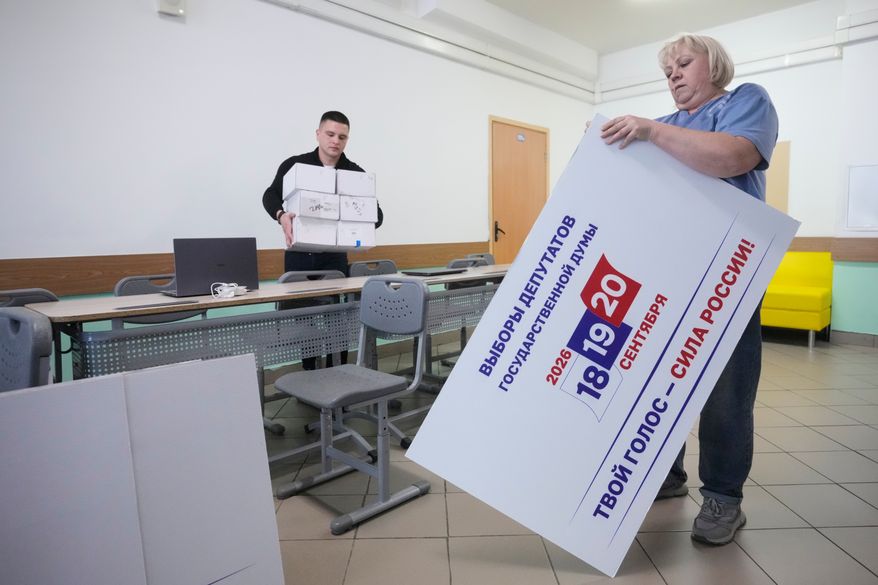 Precinct election commission members set up a polling station for the upcoming parliamentary elections in Moscow, on Thursday, Sept. 17, 2026. (AP Photo/Pavel Bednyakov)