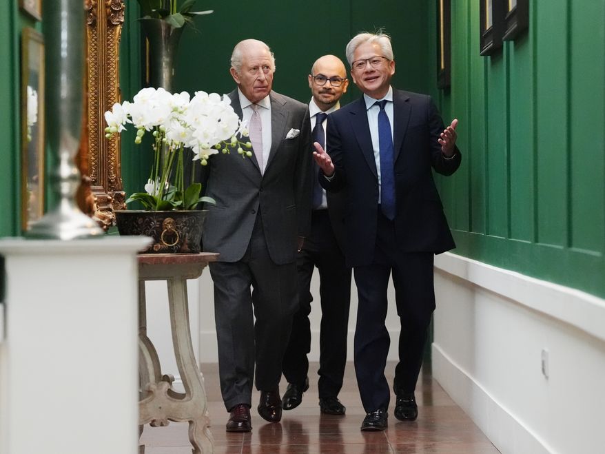 Britain's King Charles III, left, walks with Nvidia chief executive Jensen Huang, right, and Sir Demis Hassabis to a meeting for leaders from the artificial intelligence (AI) sector, government, and thought leaders to discuss how AI can be developed and deployed in ways that benefit society, at Dumfries House in Cumnock, Scotland, Thursday Sept. 17, 2026. (Jonathan Brady/PA via AP, Pool)