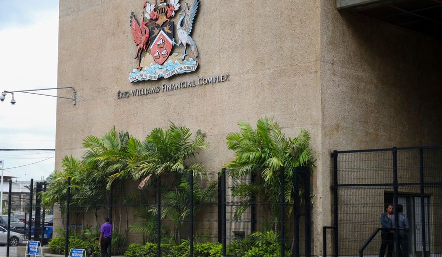 The country's coat of arms hangs on the facade of a government building in Port-of-Spain, Trinidad and Tobago, Aug. 20, 2024. (AP Photo/Ash Allen, File)