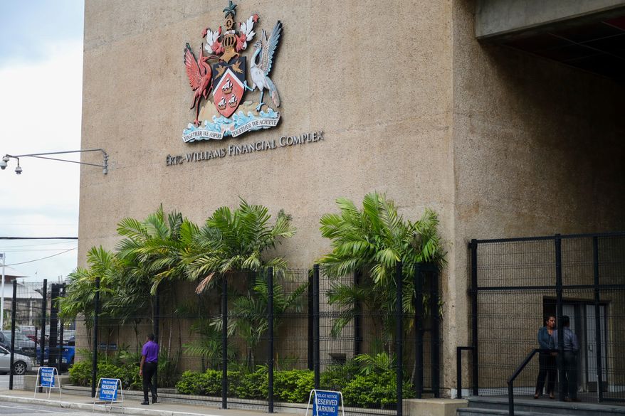 The country's coat of arms hangs on the facade of a government building in Port-of-Spain, Trinidad and Tobago, Aug. 20, 2024. (AP Photo/Ash Allen, File)