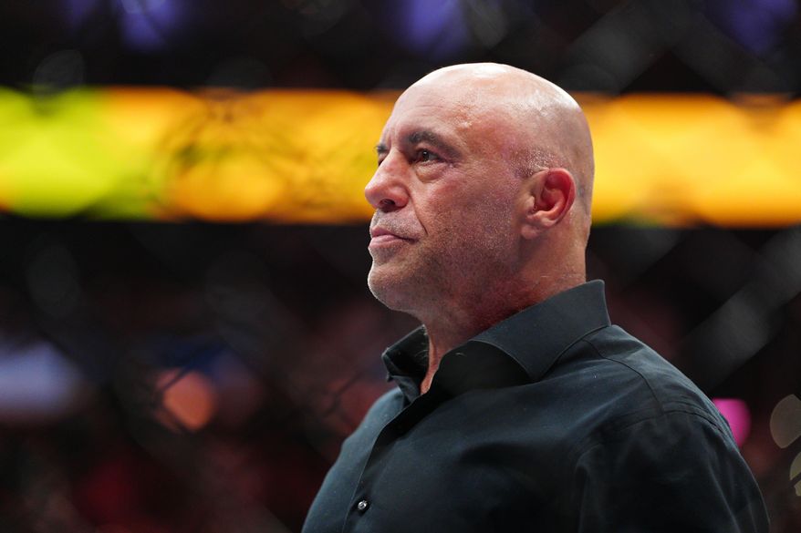 UFC commentator Joe Rogan stands in the arena after welterweight title fight at the UFC 330 mixed martial arts event Sunday, Aug. 16, 2026, in Philadelphia. (AP Photo/Derik Hamilton)