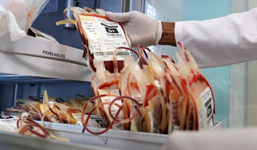 A specialist handles blood bags inside a laboratory at a hospital during a regional congress focused on strengthening laboratory capacity and preparedness following lessons from Ebola and COVID-19, in Lome, Togo, Wednesday, Sept. 16, 2026. (AP Photo/Erick Kaglan)
